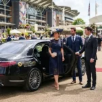 Royal Ascot racecourse entrance with elegant visitors arriving from Reading by private car